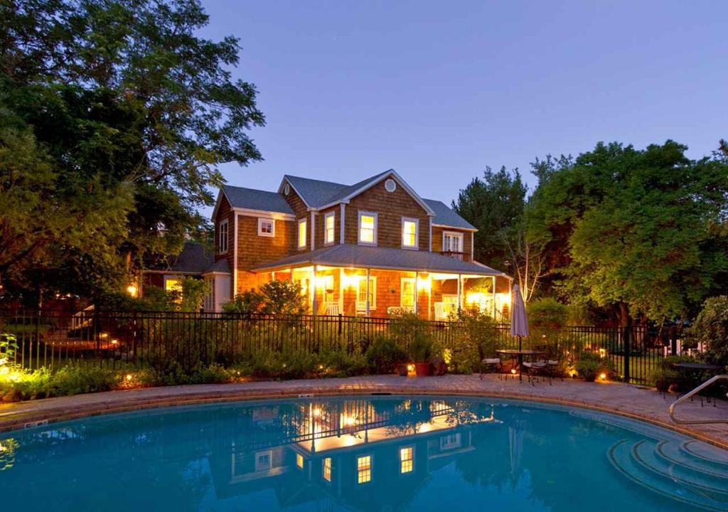 a house with a swimming pool in front of a house at Sunflower Hill Inn in Moab