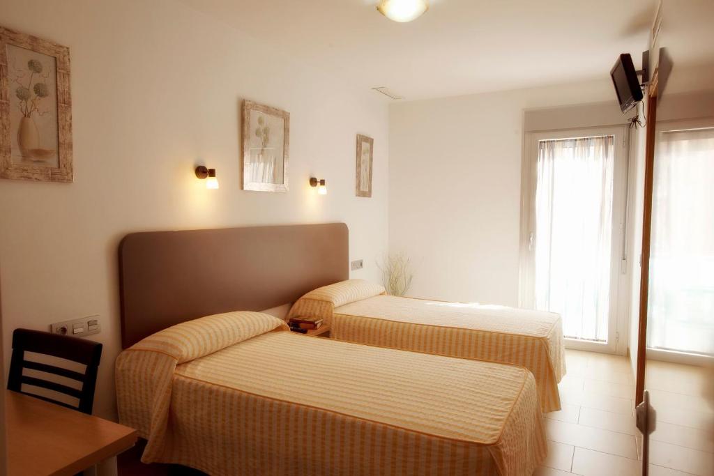 Postel nebo postele na pokoji v ubytování Hostal San Marcos