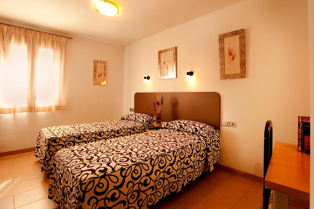 Postel nebo postele na pokoji v ubytování Hostal San Marcos