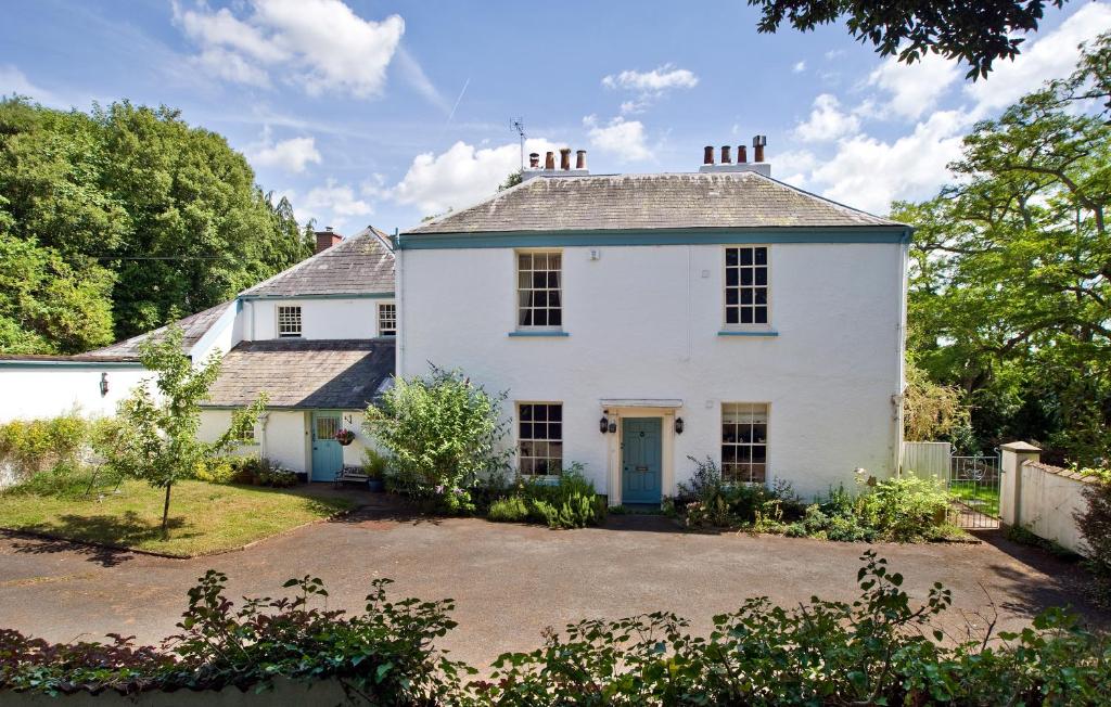 a white house with a driveway in front of it at The Old Vicarage B&B in Kenton