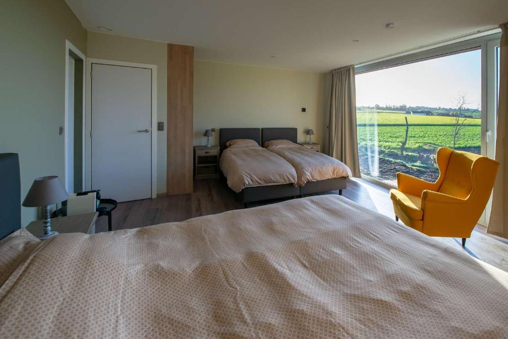 Postel nebo postele na pokoji v ubytování B&B 't Oezent