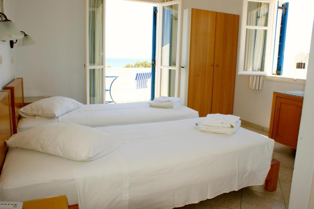 Łóżko lub łóżka w pokoju w obiekcie Blue Bay Villas