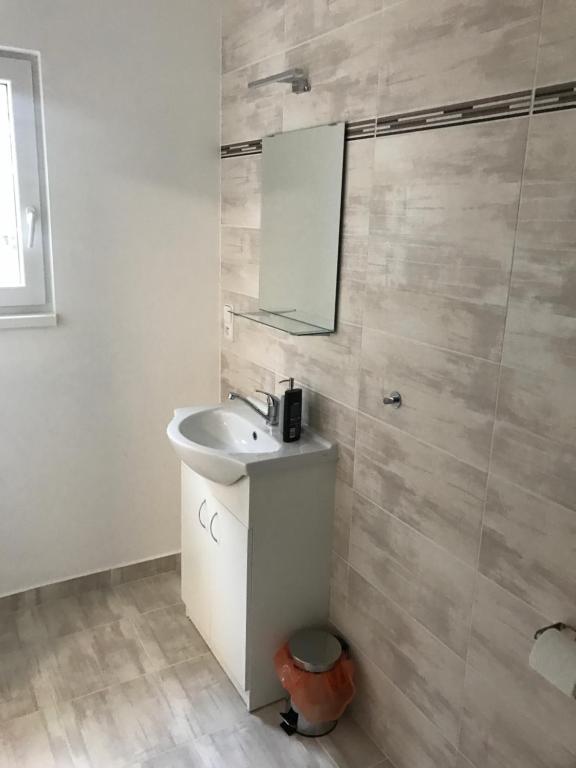 łazienka z umywalką i lustrem w obiekcie Apartment Šarka w mieście HoÅ¡Å¥ka