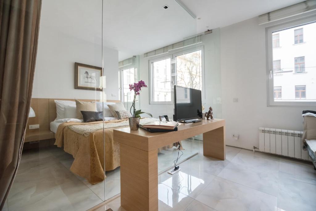 a bedroom with a bed and a desk with a computer at Feel Home in Vienna in Vienna