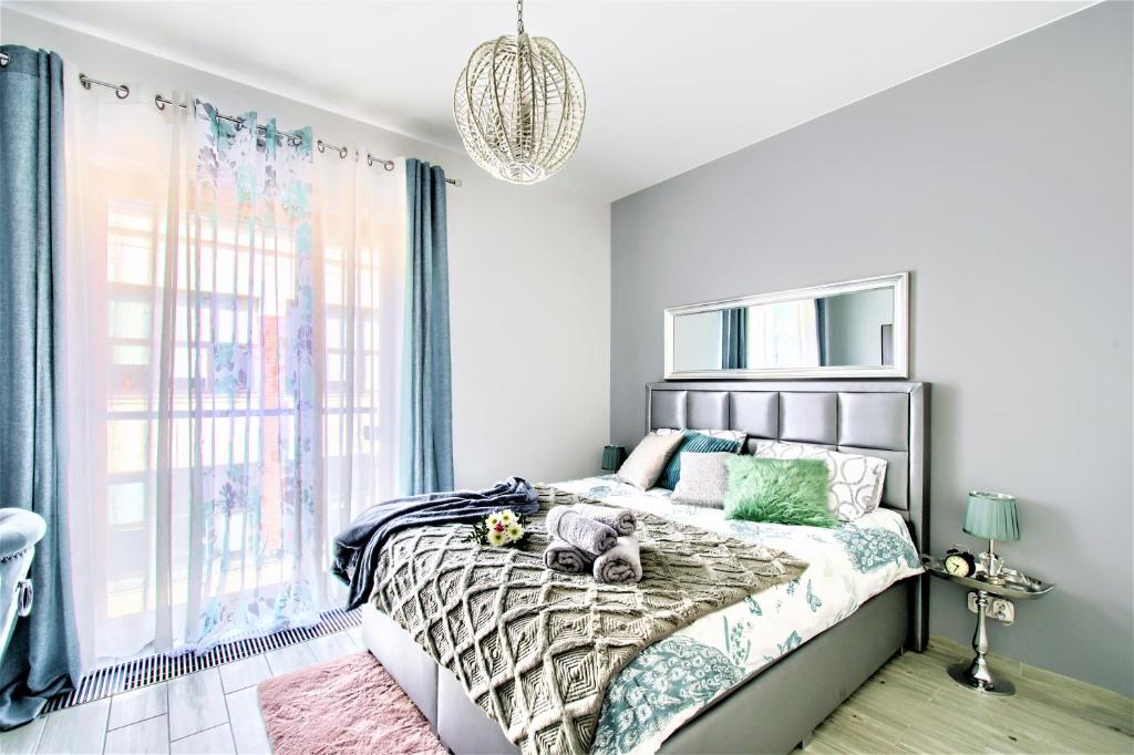 Кровать или кровати в номере Aparthotel Pawia Deluxe