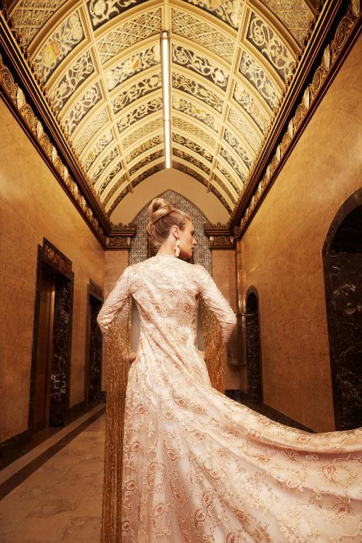 a woman in a wedding dress standing in a room at EXchange Hotel Vancouver in Vancouver