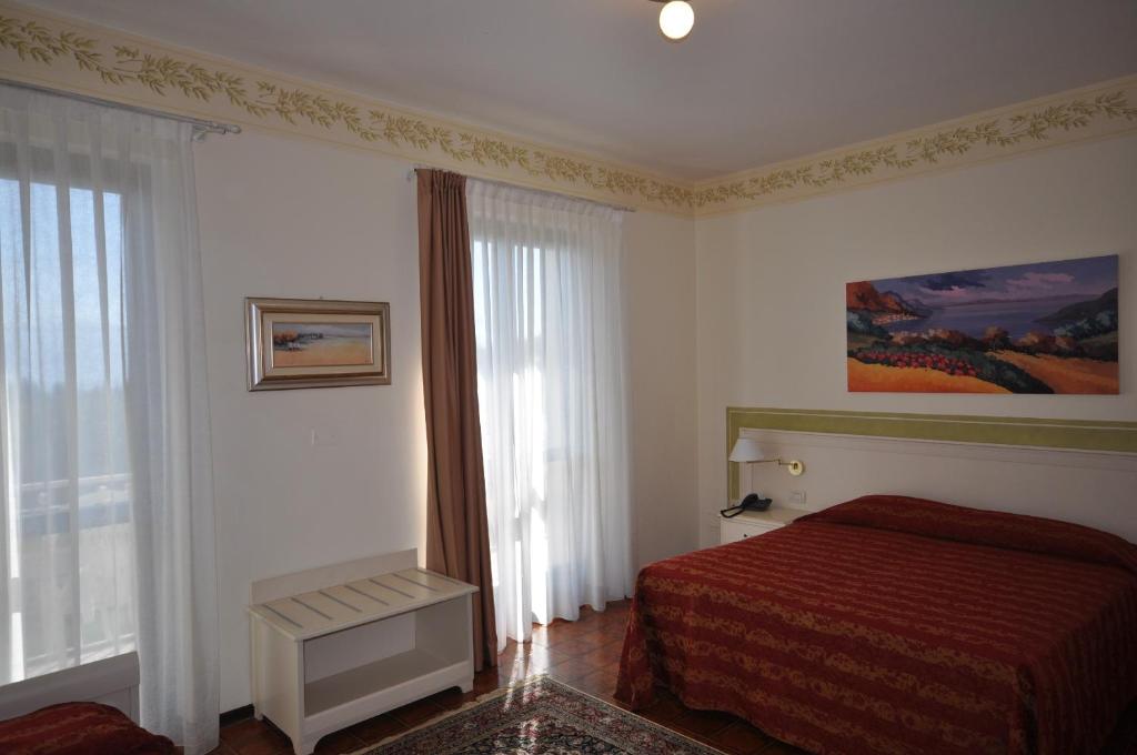 Postel nebo postele na pokoji v ubytování Hotel Panoramica