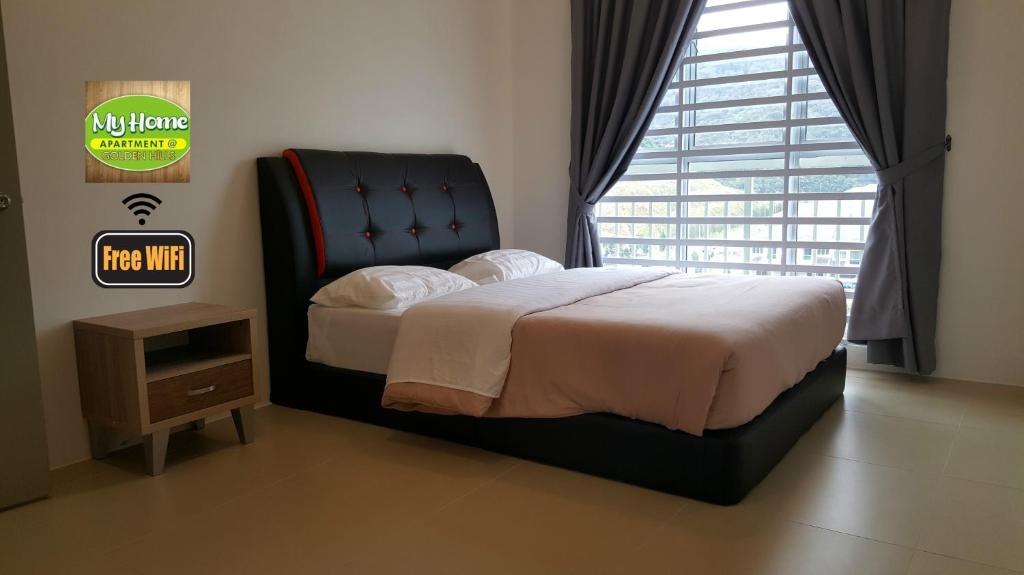 a bedroom with a bed and a large window at My Homestay S1311 - Golden Hills Night Market in Cameron Highlands