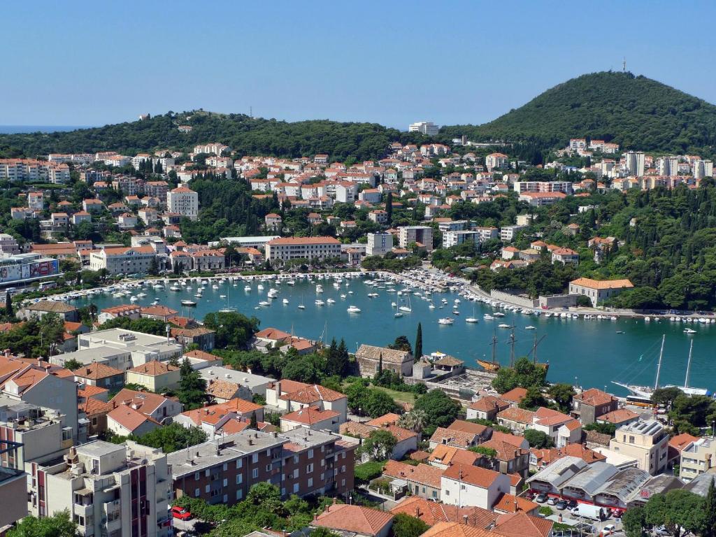 an aerial view of a city with boats in a harbor at Hotel Adria in Dubrovnik