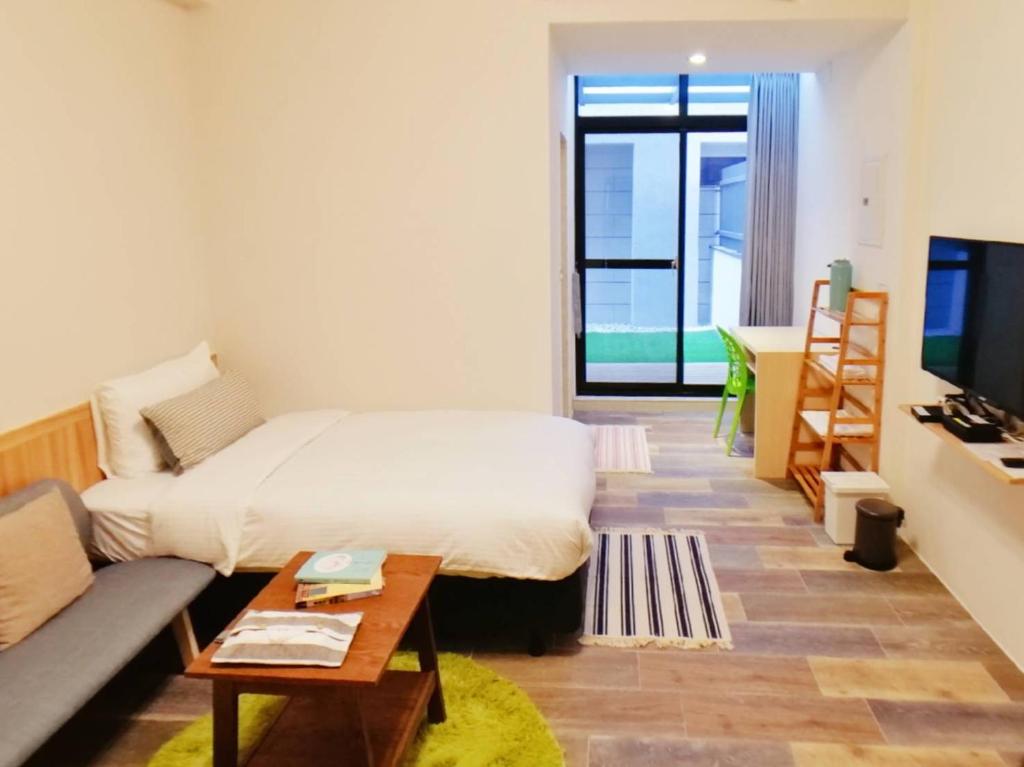Postel nebo postele na pokoji v ubytování See U Tainan Apartment