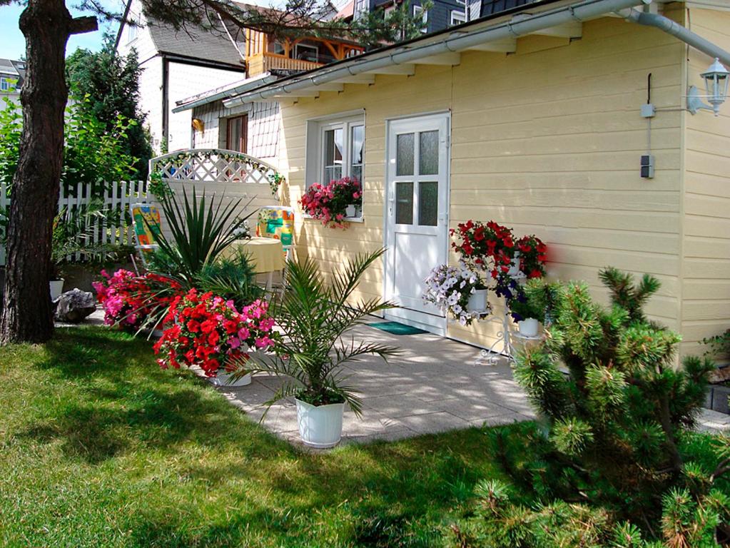 a house with flowers in front of a door at Ferienhaus Wurzelbergblick in Masserberg