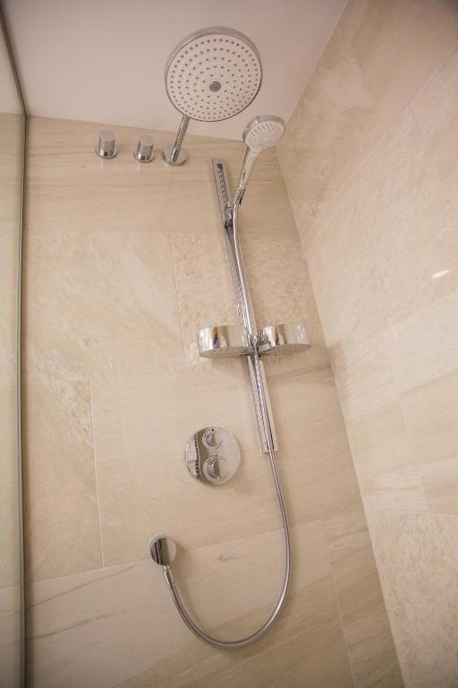 a shower with a shower head in a bathroom at Hotel Galatea in Mladá Boleslav