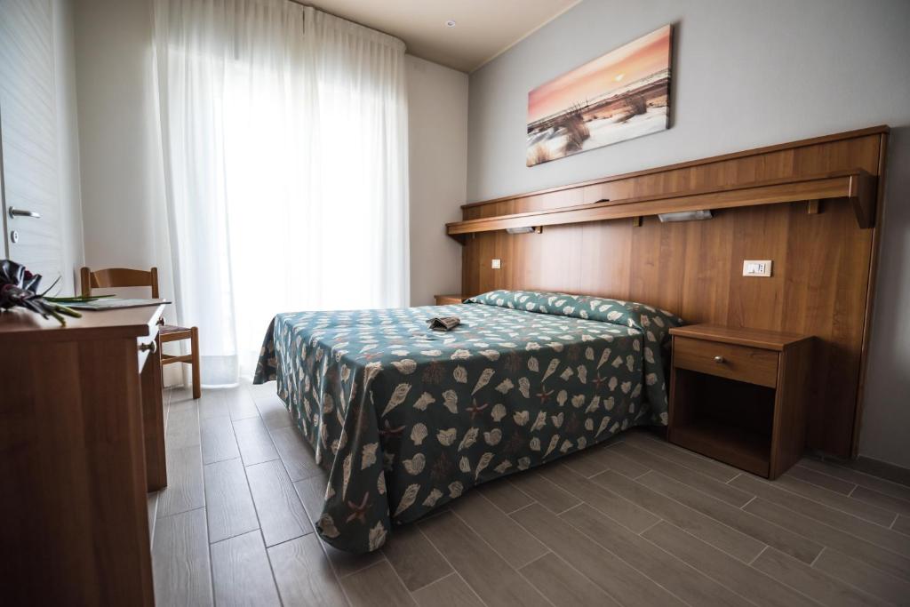Postel nebo postele na pokoji v ubytování Hotel Jesolo Sand
