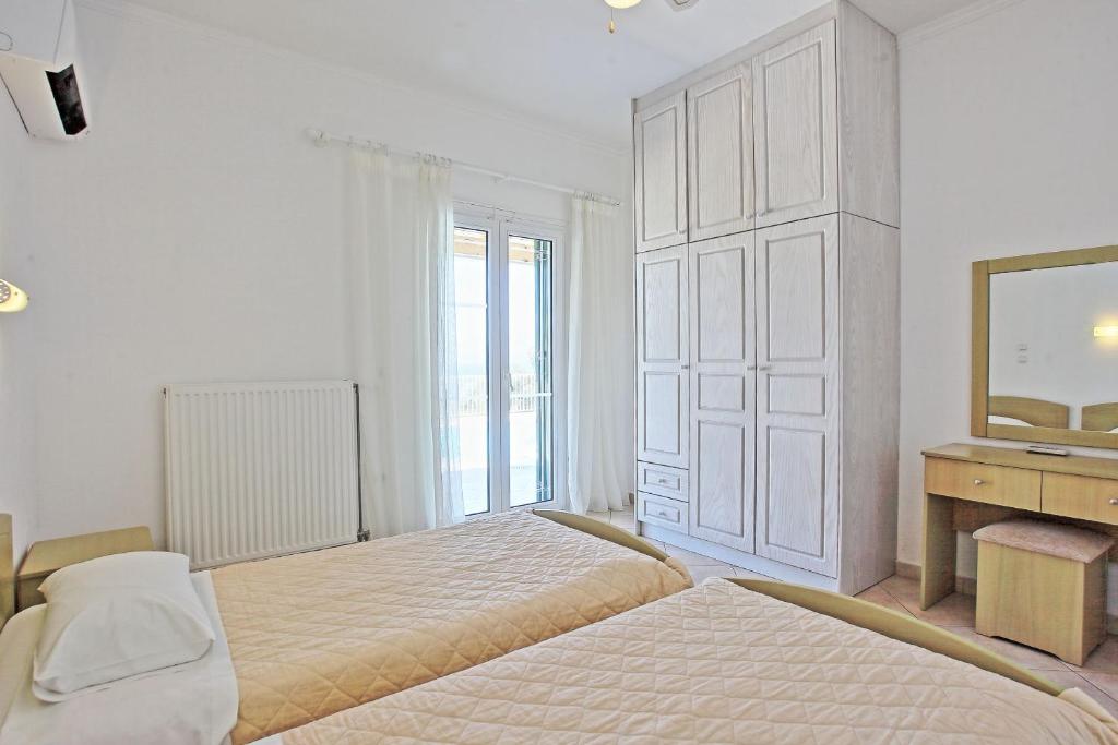 Postel nebo postele na pokoji v ubytování Beach Villa Oneiro