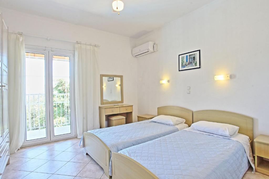 Postel nebo postele na pokoji v ubytování Beach Villa Oneiro