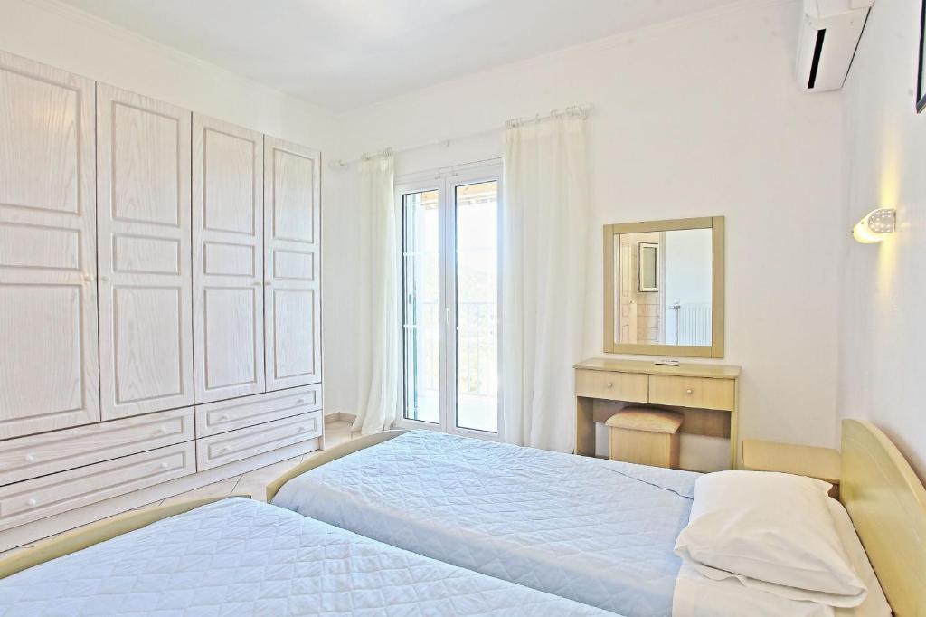 Postel nebo postele na pokoji v ubytování Beach Villa Oneiro