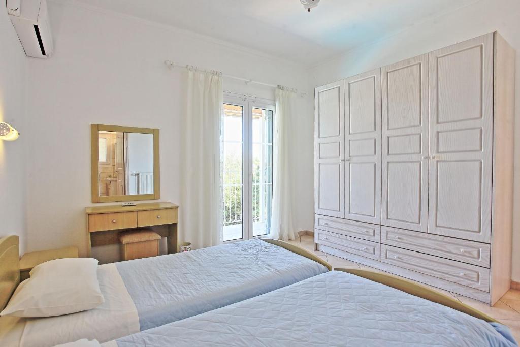 Postel nebo postele na pokoji v ubytování Beach Villa Oneiro