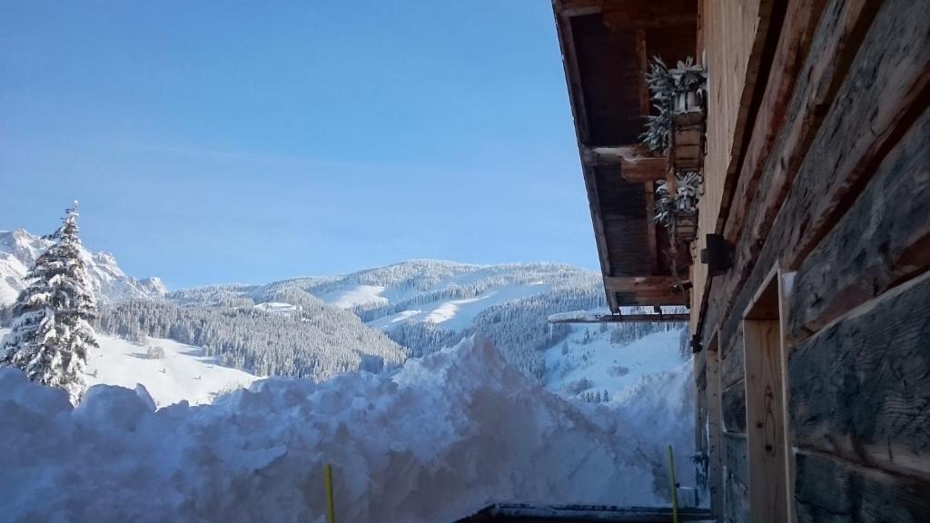 a view of a snowy mountain from a building at Tauernwelt - Chalet Hochkönigblick in Maria Alm am Steinernen Meer