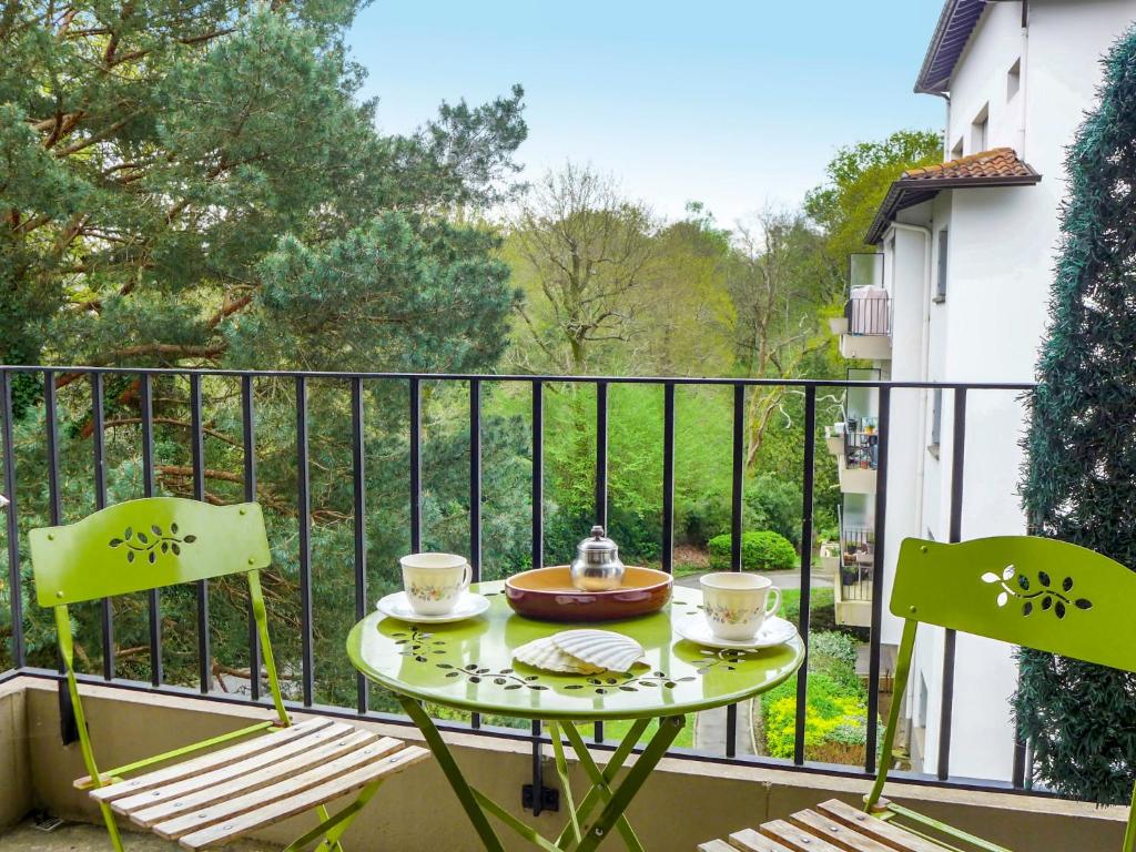 a table and chairs on a balcony with a view at Apartment Demeures de Maignon by Interhome in Anglet