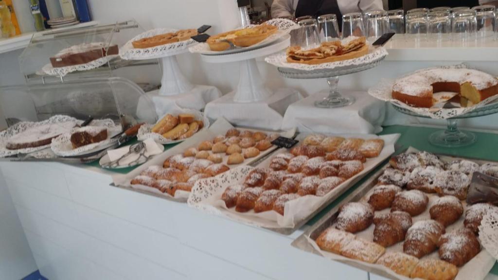 a display of different types of pastries on a table at Relais Maresca Luxury Small Hotel & Terrace Restaurant in Capri