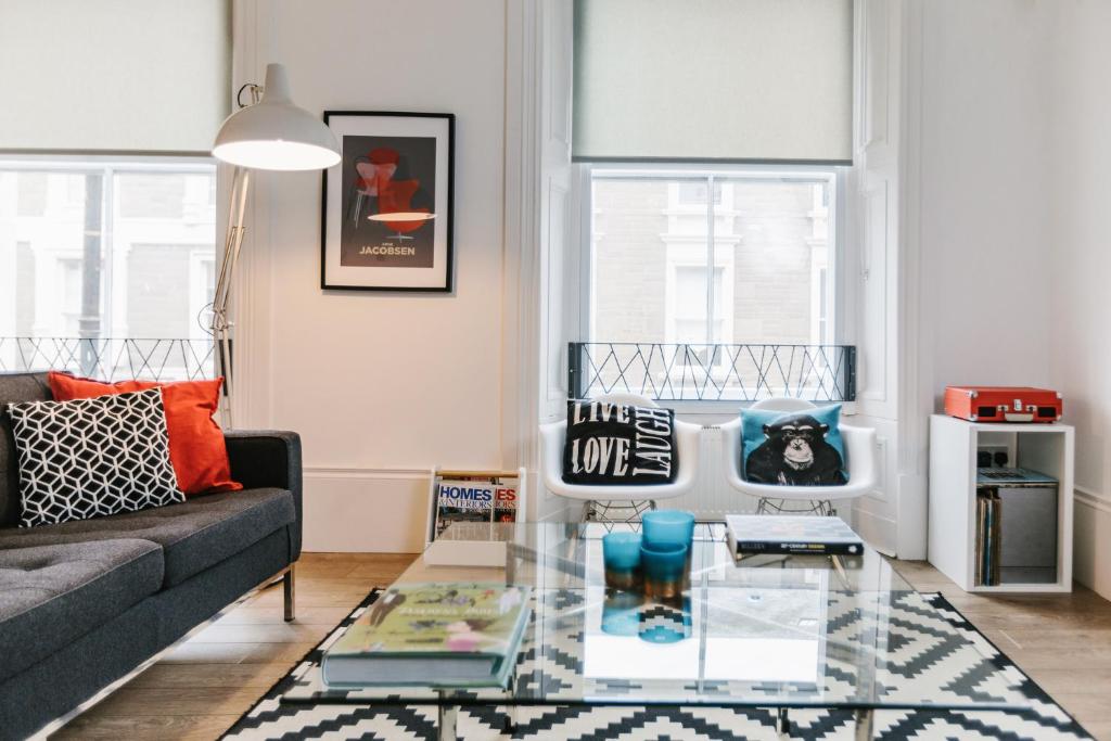 a living room with a couch and a glass table at Urban Quarters in Dundee