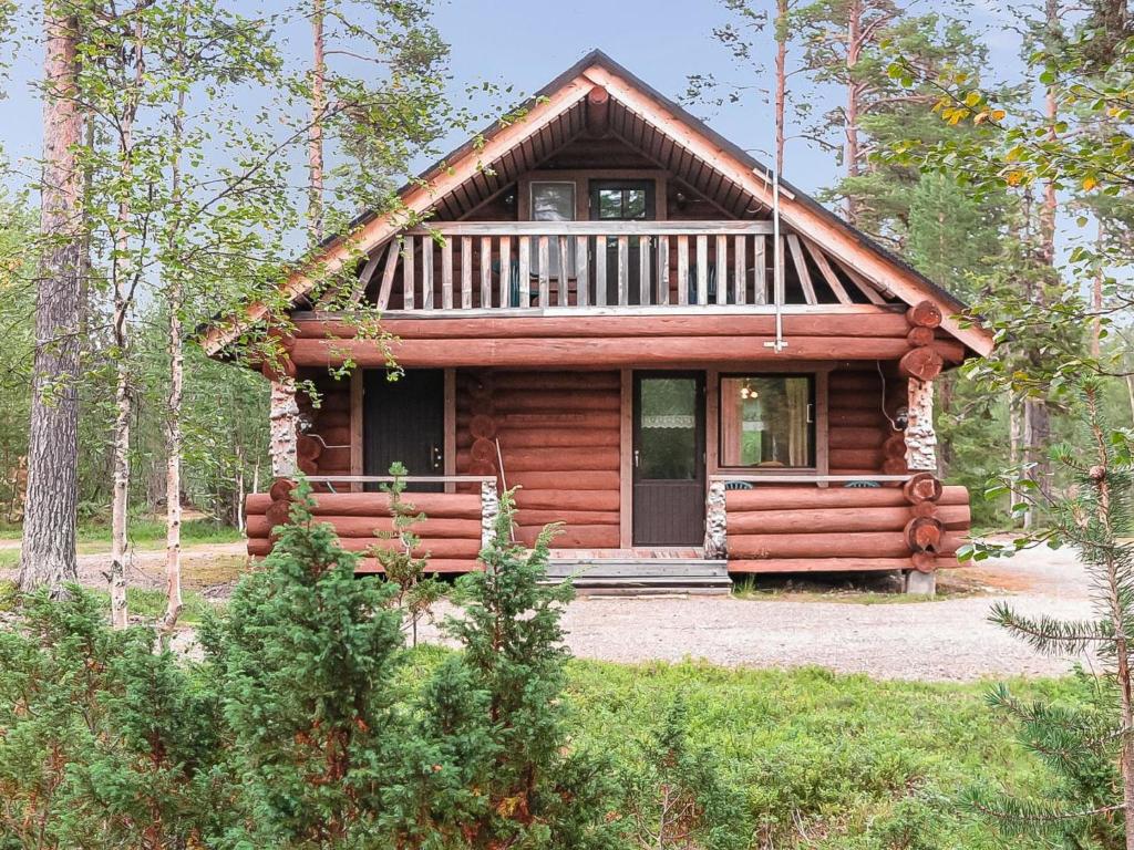 a log cabin in the woods with a porch at Holiday Home Jäkälä by Interhome in Kyrö