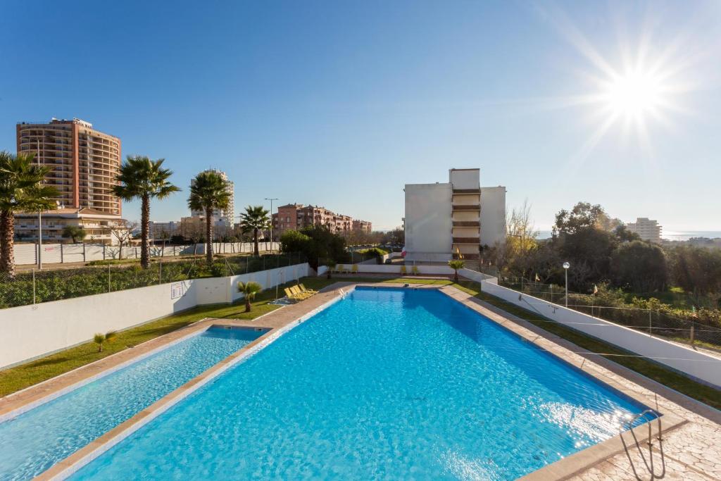 a swimming pool on the roof of a building at Edifício Rocha Vau Beach Apartment in Portimão