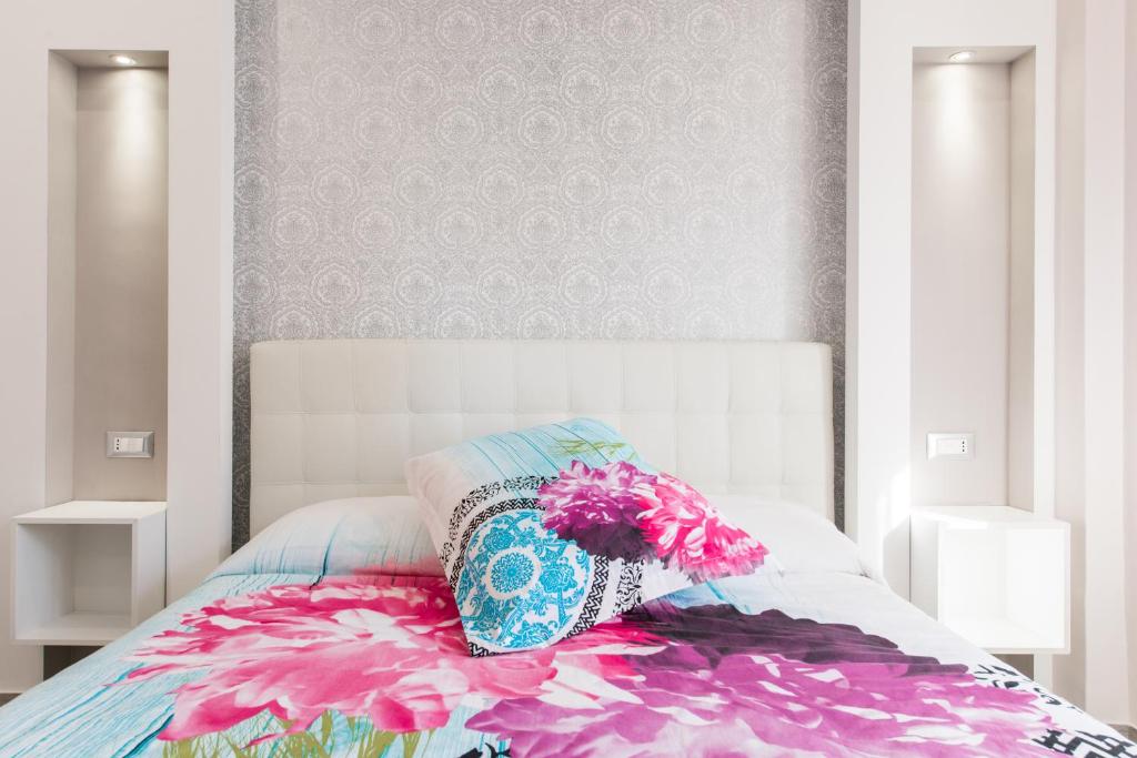 A bed or beds in a room at La Fiaba Roma Apartment