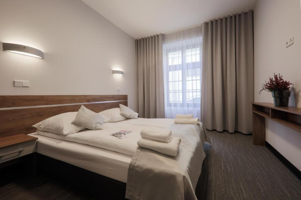 a hotel room with a large bed and a window at Kamienica Pod Aniołami in Wrocław