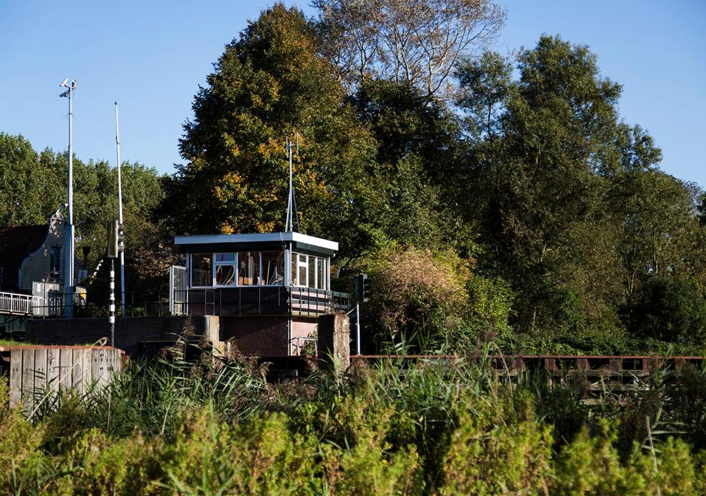 a small train on a track with trees in the background at SWEETS - Buiksloterdraaibrug in Amsterdam