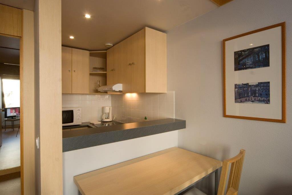 a kitchen with a table and a counter top at Inter-Résidences Paris XV in Paris