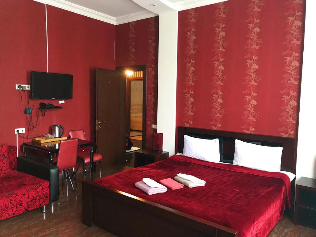 Postel nebo postele na pokoji v ubytování Hotel Aragvi