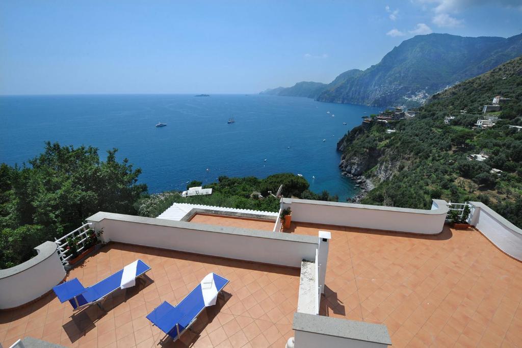 a house with two chairs and a view of the water at Villa Valeria in Positano