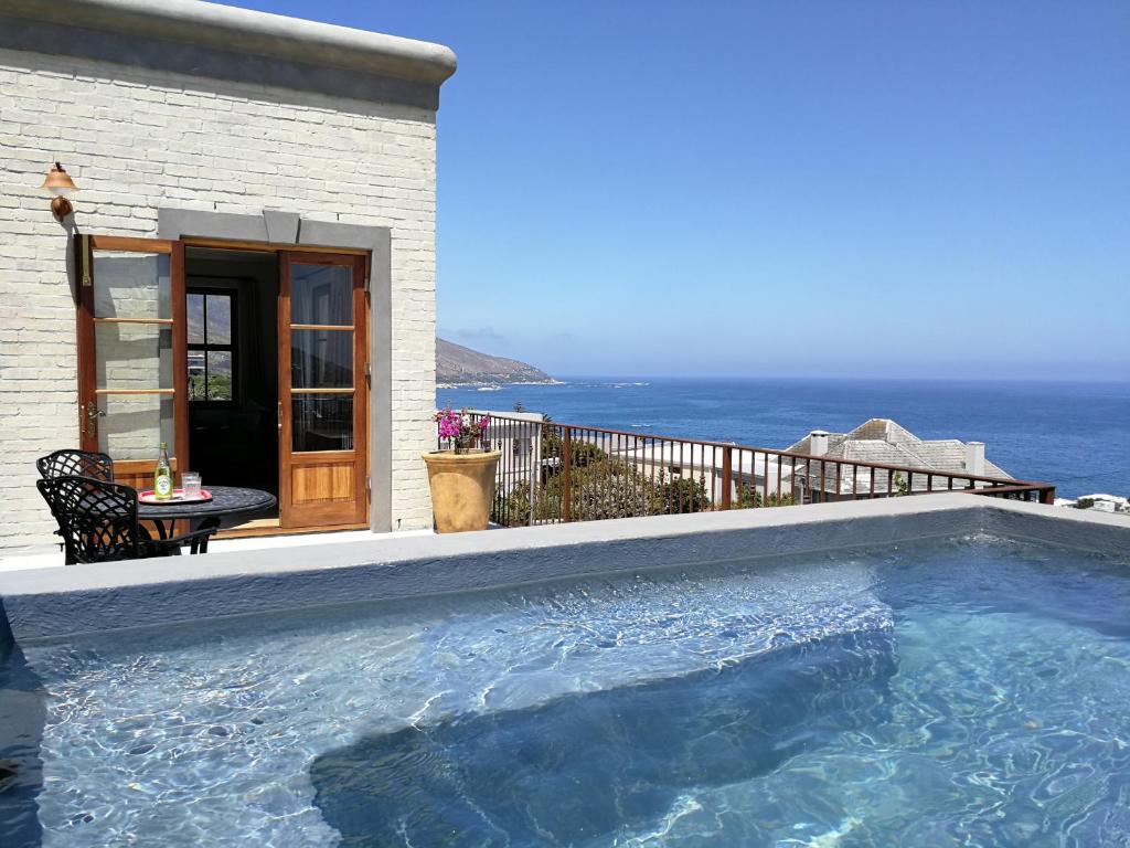 a swimming pool with a view of the ocean at Bakovenbay Luxury Suites in Cape Town