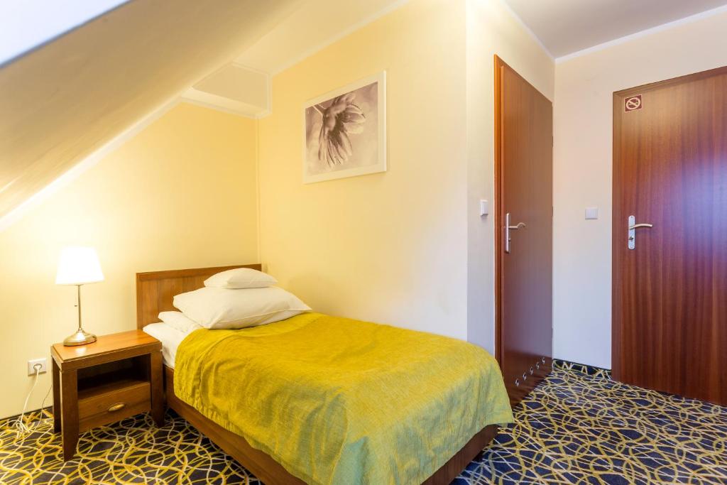 Postel nebo postele na pokoji v ubytování Hotel Relaks Wellness & SPA