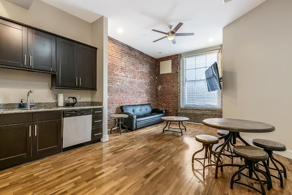 a kitchen and living room with a table and chairs at Stunning Apartments Close to City Attractions in New Orleans