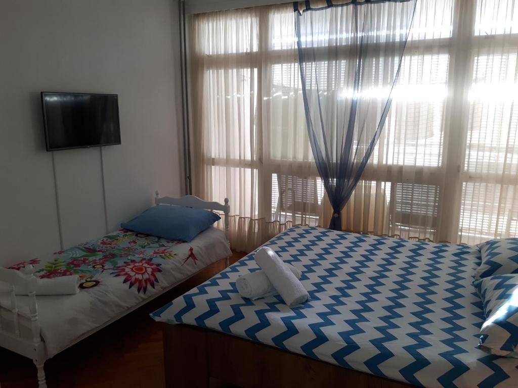 Postel nebo postele na pokoji v ubytování Tajc Rooms