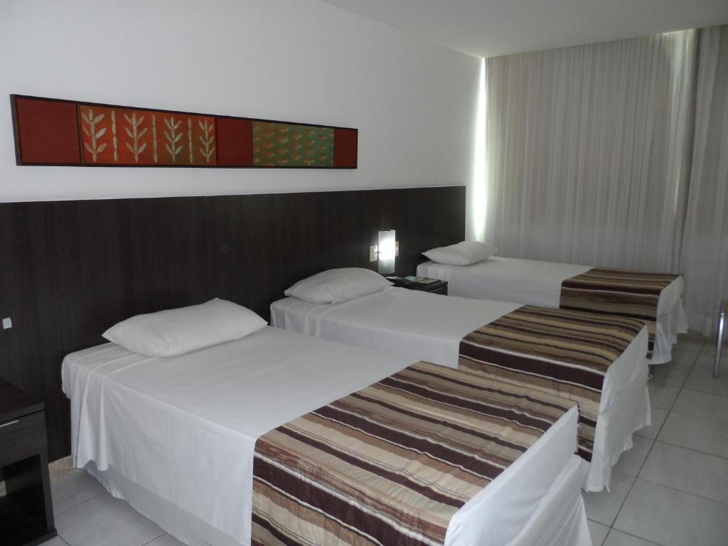 Postel nebo postele na pokoji v ubytování Cambuci Hotel