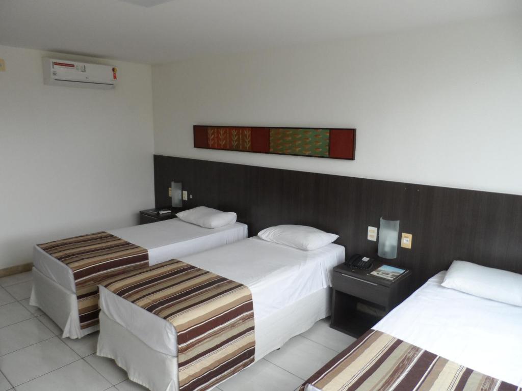 Postel nebo postele na pokoji v ubytování Cambuci Hotel