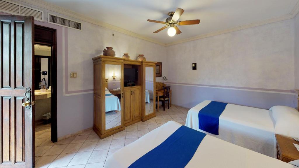 Postel nebo postele na pokoji v ubytování Hotel Boutique La Mision De Fray Diego
