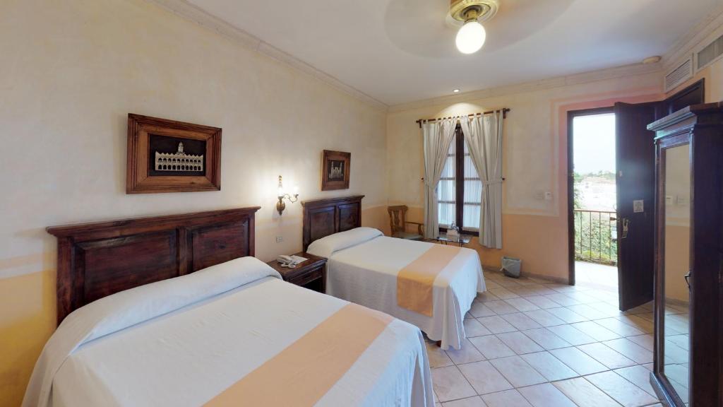 Postel nebo postele na pokoji v ubytování Hotel Boutique La Mision De Fray Diego