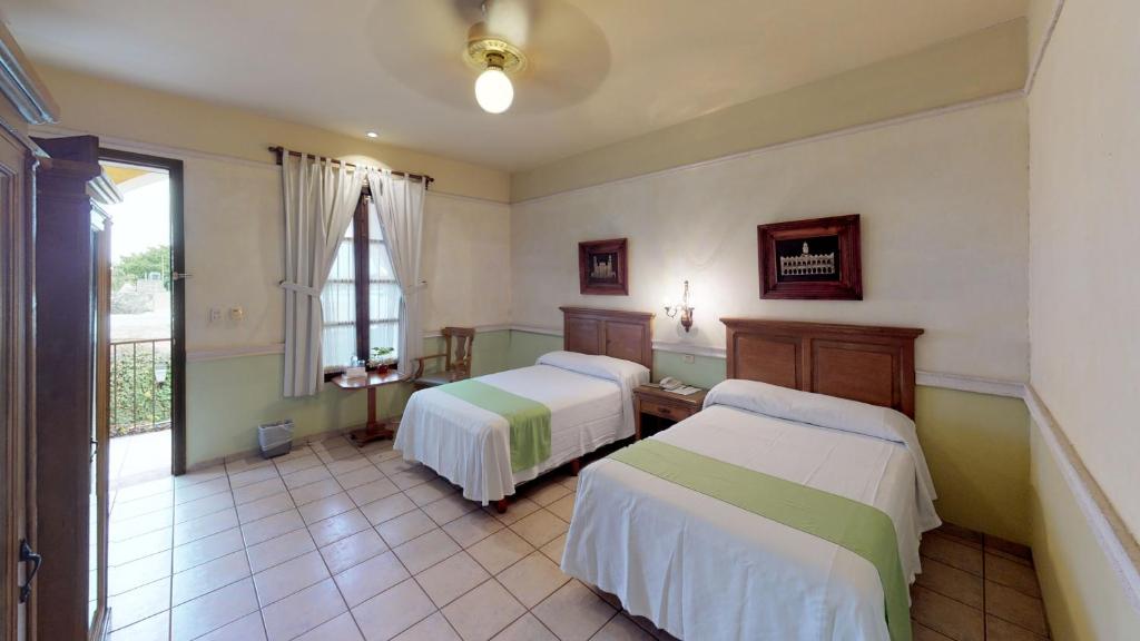 Postel nebo postele na pokoji v ubytování Hotel Boutique La Mision De Fray Diego
