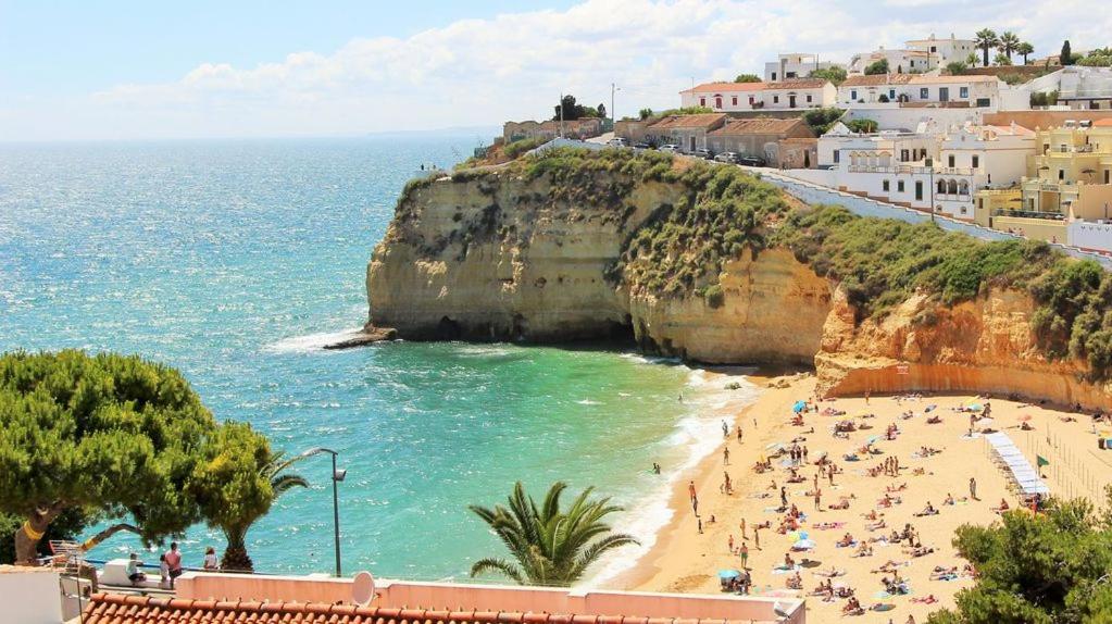 a group of people on a beach next to the ocean at CASA CEDRO - VISTA MAR 2 in Carvoeiro