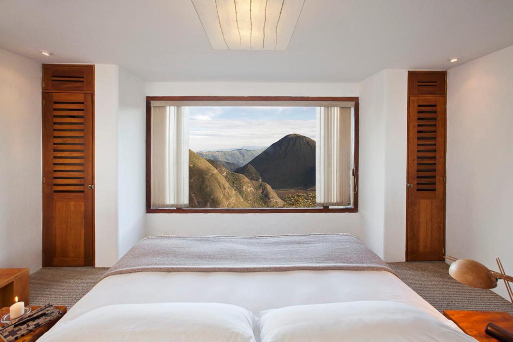 a bedroom with a large window with a mountain view at El Crater in San Antonio