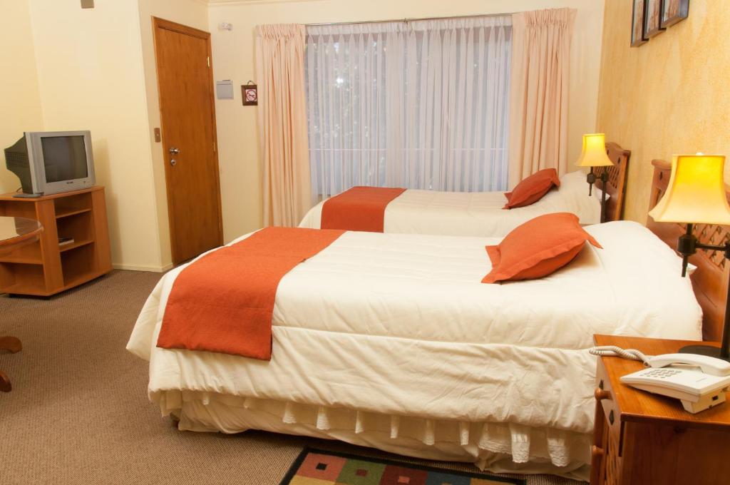 Voodi või voodid majutusasutuse Apart Hotel Blumenau toas