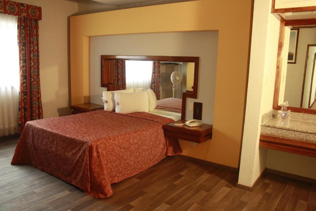 Postel nebo postele na pokoji v ubytování Hotel Mina