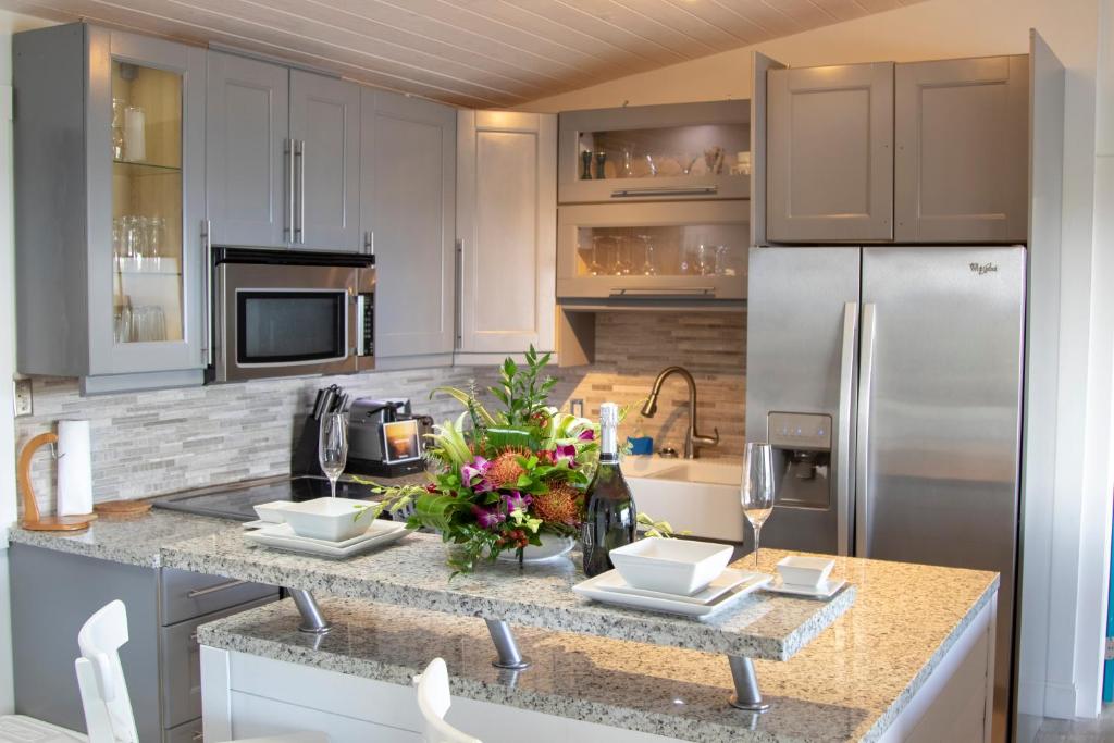 a kitchen with white cabinets and a counter with a refrigerator at Marina Vista St. Thomas in St Thomas