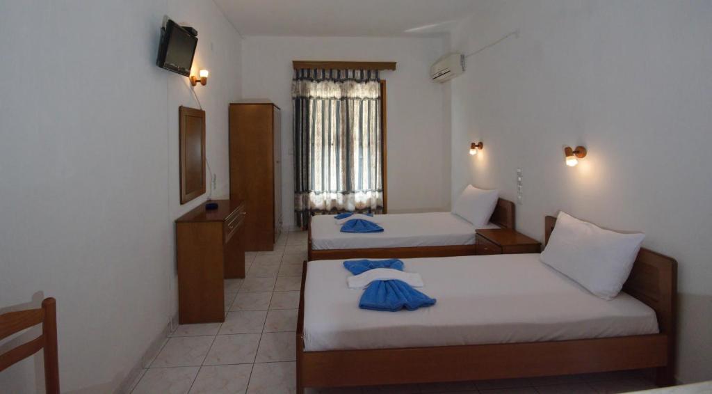 Postel nebo postele na pokoji v ubytování NIKIS ROOMS