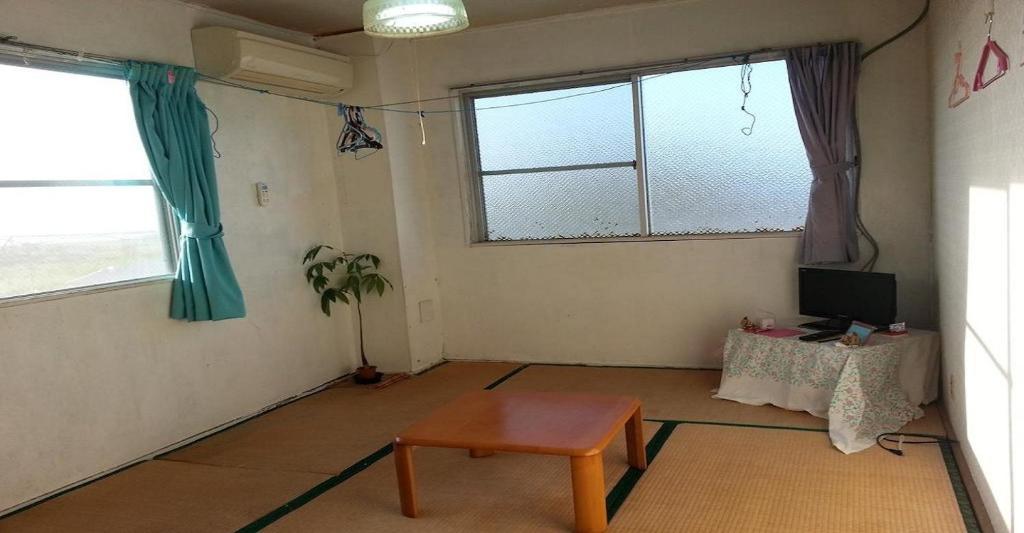 a living room with a table and two windows at Oshima-gun - Hotel / Vacation STAY 14384 in Furusato