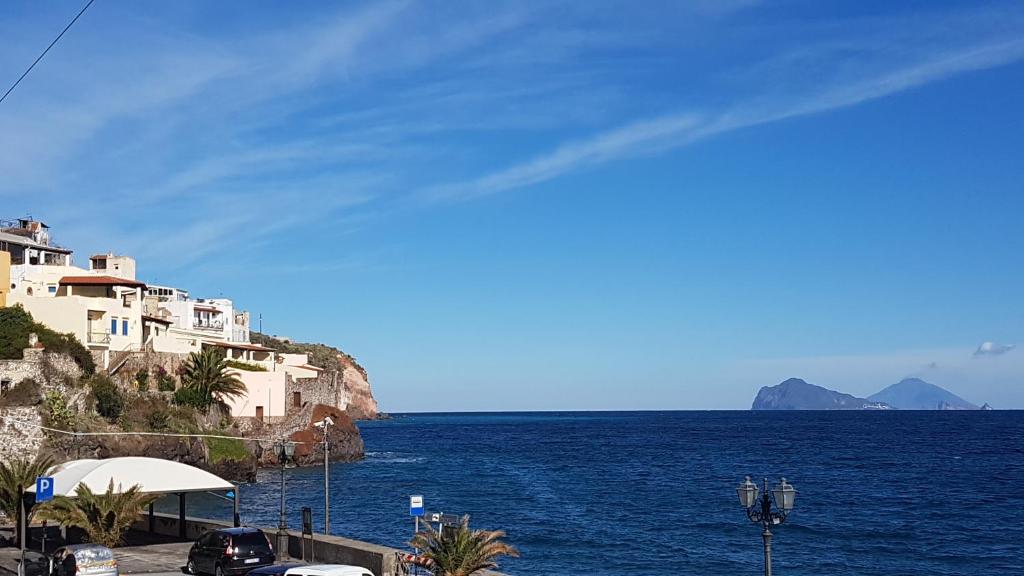 a view of the ocean and houses on a cliff at La casa sul mare in Lipari